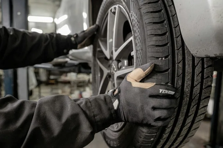 A man working on a tire in a garage